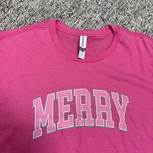 Bright pink Christmas T-shirt. “Merry” short sleeves.